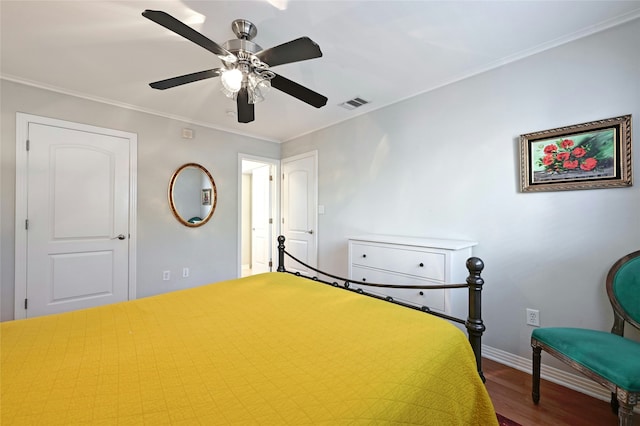 bedroom with hardwood / wood-style floors, ceiling fan, and ornamental molding