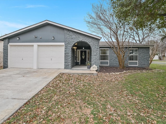 single story home featuring a front yard and a garage