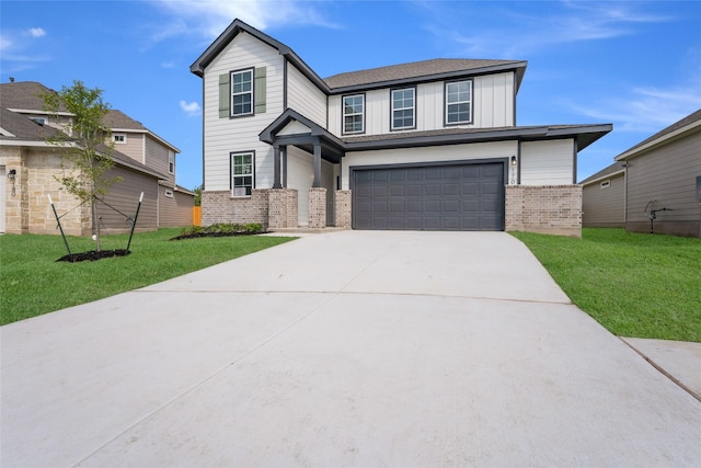 view of front of property featuring a garage and a front lawn