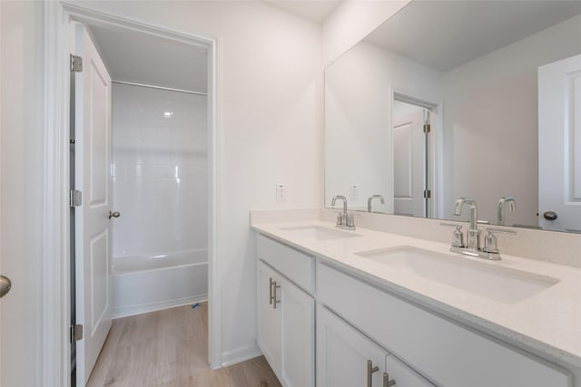 bathroom featuring hardwood / wood-style flooring, bathtub / shower combination, and vanity