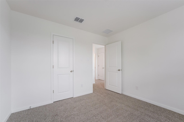 unfurnished bedroom with light carpet