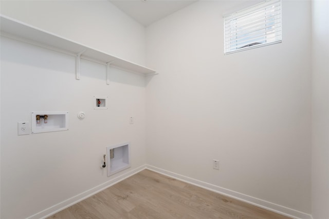 laundry room with gas dryer hookup, light hardwood / wood-style floors, and hookup for a washing machine