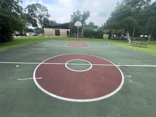 view of sport court with a lawn