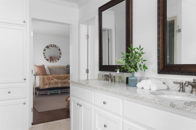 ensuite bathroom featuring double vanity, crown molding, a sink, and ensuite bathroom