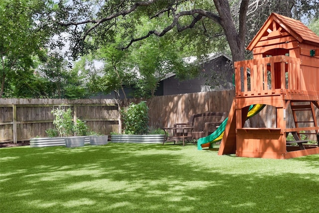 view of yard with a fenced backyard and a playground