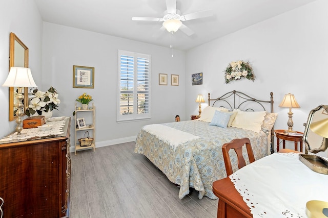 bedroom featuring hardwood / wood-style floors and ceiling fan