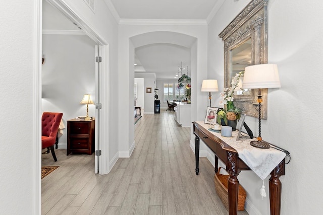 hallway with ornamental molding and light wood-type flooring