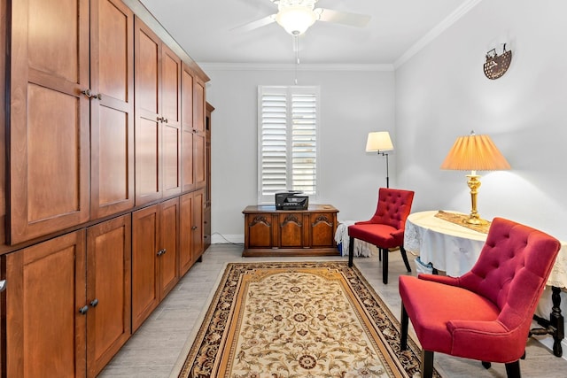 sitting room with ceiling fan, light wood-type flooring, and crown molding