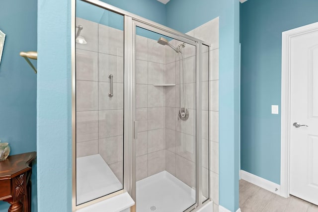 bathroom featuring a shower with shower door