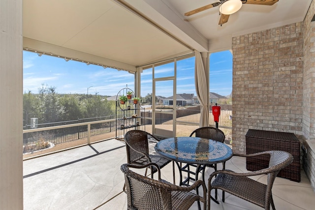 sunroom / solarium with ceiling fan and plenty of natural light