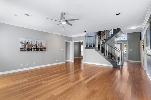 unfurnished living room with ceiling fan, visible vents, baseboards, stairway, and light wood finished floors