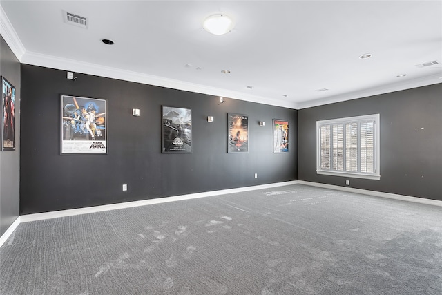 empty room featuring carpet floors, baseboards, visible vents, and ornamental molding