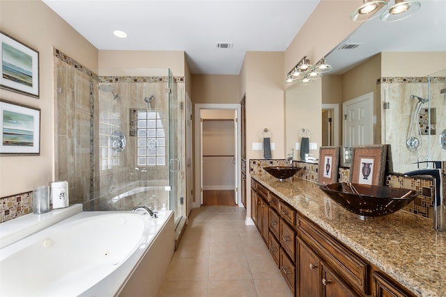 bathroom with tile patterned floors, independent shower and bath, and vanity