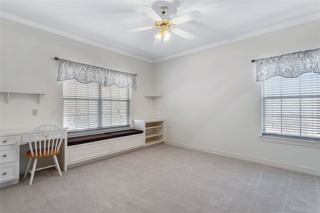 unfurnished office with ceiling fan, ornamental molding, baseboards, and light colored carpet