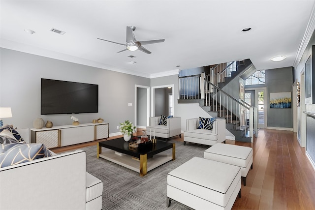 living room featuring visible vents, stairway, ornamental molding, wood finished floors, and baseboards