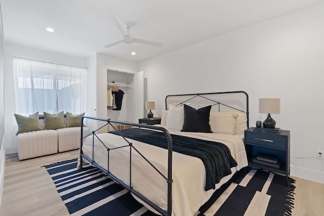 bedroom with a closet, ceiling fan, and light hardwood / wood-style flooring