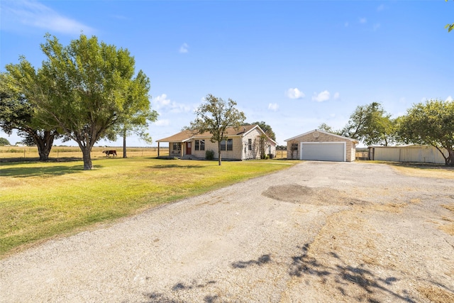 single story home with a garage, a front yard, and an outdoor structure