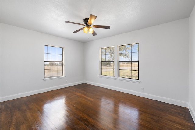 spare room featuring ceiling fan and dark hardwood / wood-style floors