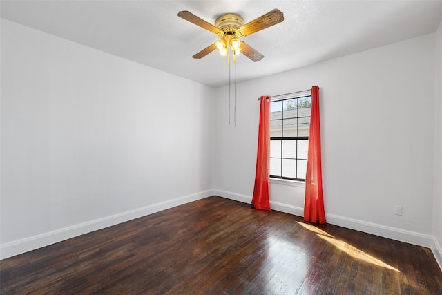 unfurnished room featuring ceiling fan and dark hardwood / wood-style flooring