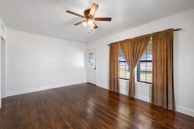 empty room featuring dark wood-type flooring and ceiling fan