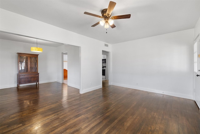 spare room with ceiling fan and dark hardwood / wood-style floors