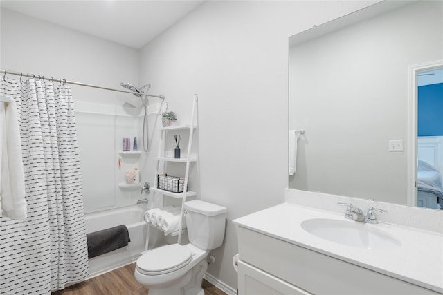 full bathroom with shower / bathtub combination with curtain, hardwood / wood-style floors, vanity, and toilet