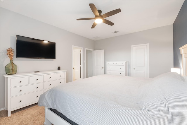 bedroom with ceiling fan and light carpet