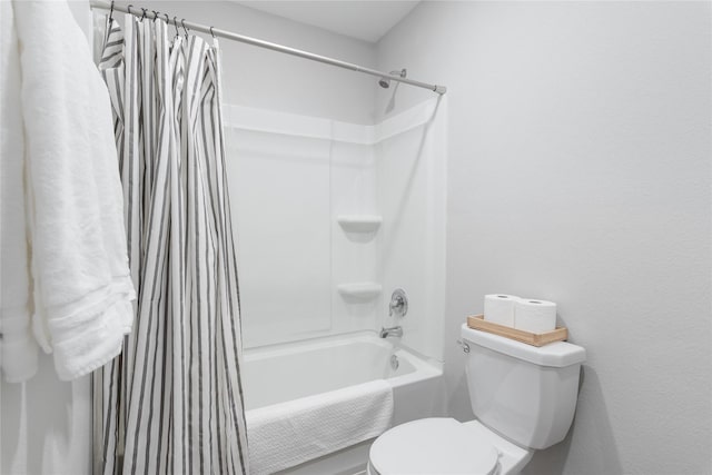 bathroom with toilet and shower / bath combo