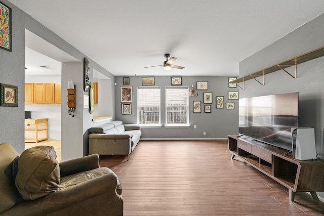 living room with hardwood / wood-style floors and ceiling fan