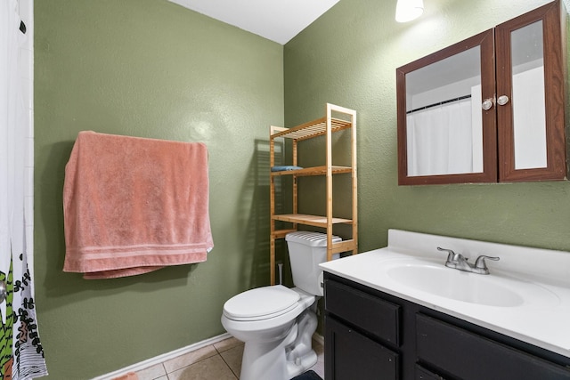 bathroom featuring toilet, vanity, and tile patterned floors