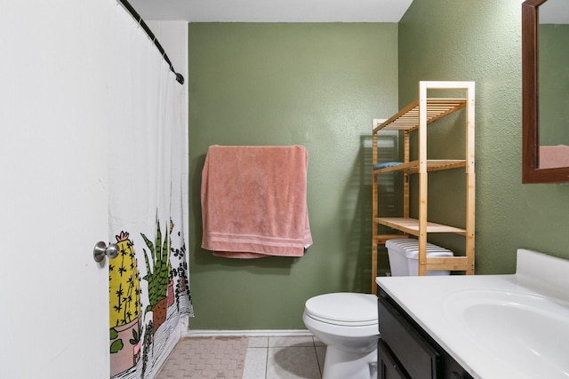 full bathroom featuring tile patterned floors, shower / bath combo with shower curtain, vanity, and toilet