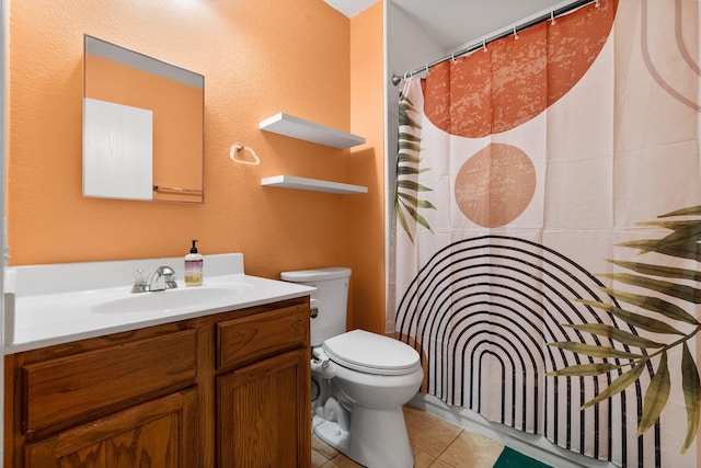 bathroom featuring toilet, tile patterned floors, and vanity