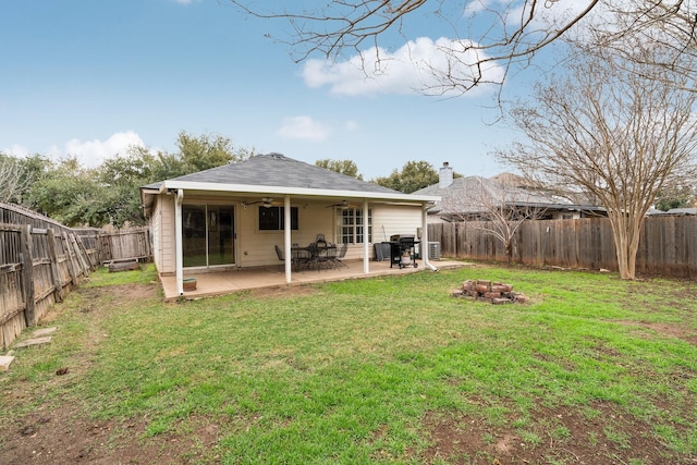 back of house with an outdoor fire pit, a patio area, ceiling fan, and a lawn