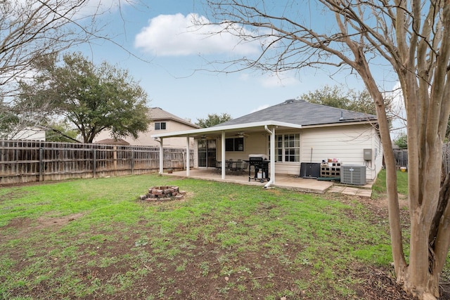 back of house with a patio area, a yard, an outdoor fire pit, cooling unit, and ceiling fan