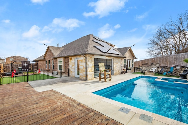 view of swimming pool featuring a patio area and a deck