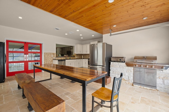 dining area with wood ceiling and french doors