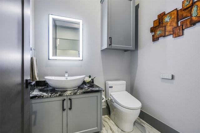 bathroom with toilet and vanity