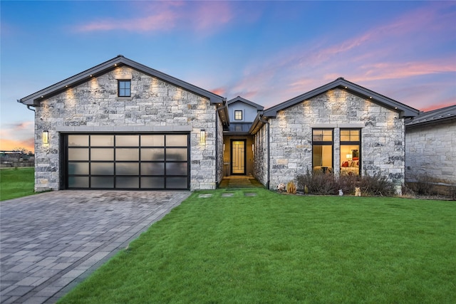 view of front facade featuring a lawn and a garage