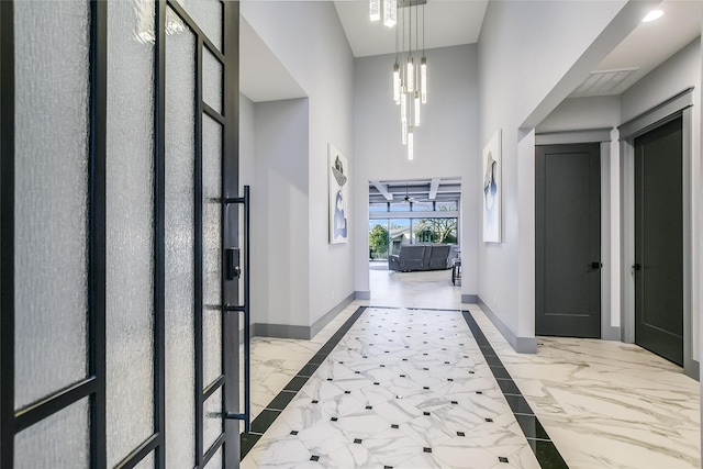 entrance foyer featuring a notable chandelier