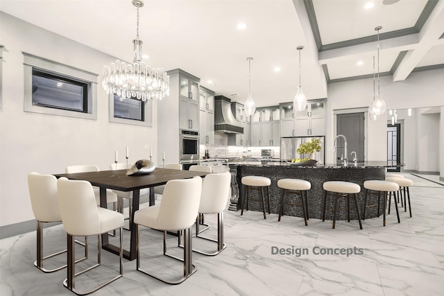 dining room featuring coffered ceiling, sink, and beam ceiling