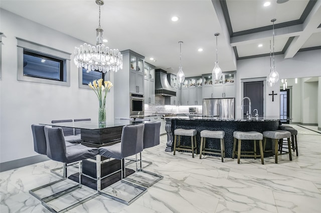 dining area featuring beam ceiling, coffered ceiling, and sink