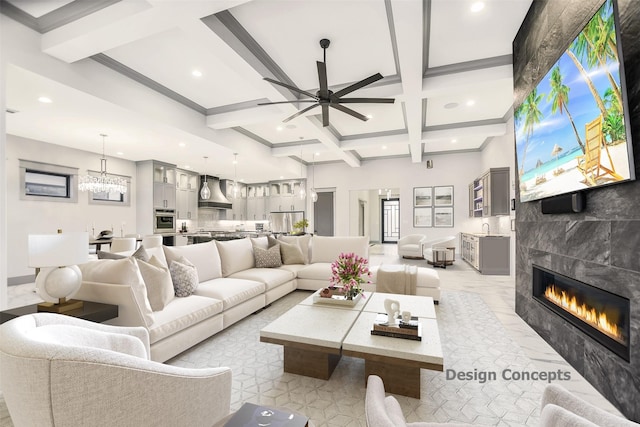 living room featuring a tiled fireplace, ceiling fan, coffered ceiling, and beam ceiling