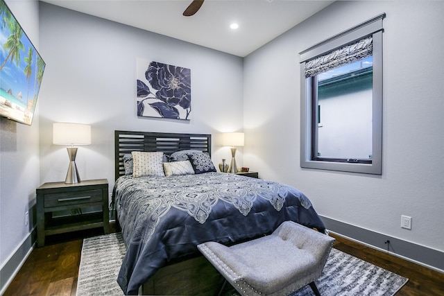 bedroom with ceiling fan and dark hardwood / wood-style floors