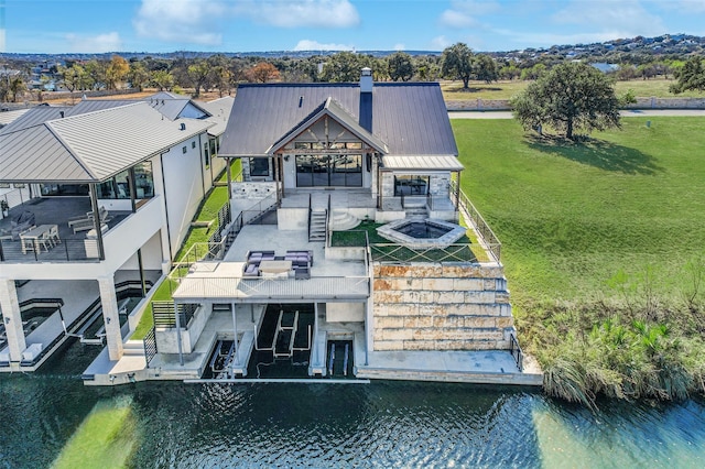 rear view of house featuring a water view