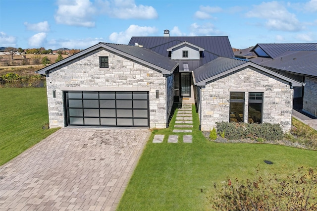 view of front of property featuring a garage and a front lawn