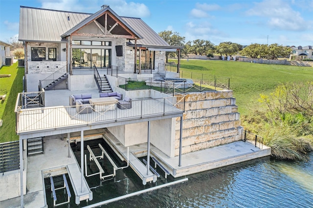 back of property featuring a yard and a water view