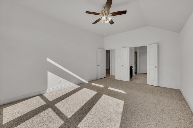 unfurnished bedroom with vaulted ceiling, light colored carpet, and ceiling fan