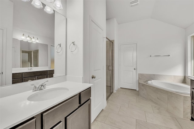 bathroom with vanity, vaulted ceiling, plus walk in shower, and tile patterned floors