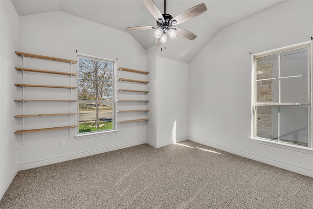 spare room featuring lofted ceiling, carpet floors, and a wealth of natural light