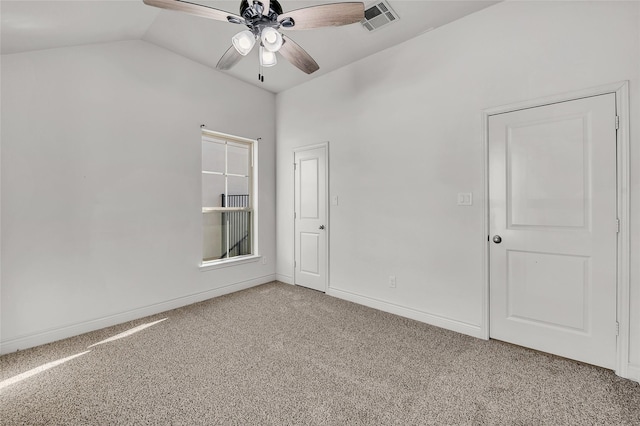 carpeted empty room featuring ceiling fan and vaulted ceiling